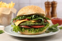 Tasty Vegetarian Burger With Spinach Cutlet, Cheese And Vegetables Served On White Table, Closeup