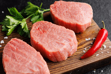 Wall Mural - Raw Steak Fresh meat veal fillet on wooden board, dark background top view