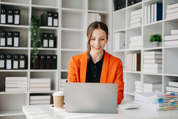 Business woman using tablet and laptop for doing math finance on an office