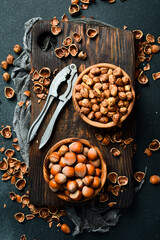 Wall Mural - Hazelnut and Tutcracker,tongs for nuts on a dark stone table. Top view. Organic food.