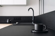 © brizmaker - Coffee cup on black kitchen countertop against blurred modern interior