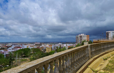 Wall Mural - Street city view with cars and traffic, house facades cityscape skyline of Huelva, Spain Cristopher Columbus birth place