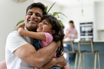 Wall Mural - Father hugging daughter at home