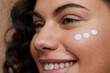 © Cultura Creative - Close-up of young woman applying face cream