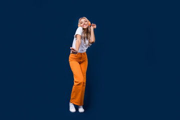 Canvas Print - Full length photo of cheerful adorable girl dj in stylish clothes dancing night club empty space isolated on dark blue color background