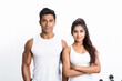 © PRASANNAPIX - happy fit young couple standing on white background.