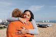 © Cultura Creative - Mother and daughter embracing on beach on sunny day