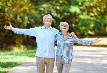 Wall Mural - woman man senior couple happy retirement together elderly active vitality park fun smiling love old nature wife happiness mature walking holding hands