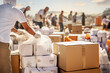 © Garnar - volunteers unload car boxes of humanitarian aid from the vehicle. For to war-affected civilians refugees in the war conflict, ensuring their safety and well-being during this crisis
