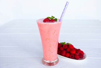 Wall Mural - Raspberry smoothie red colorful fruit juice milkshake blend beverage healthy high protein the taste yummy In glass drink episode morning on white wood background from top view.