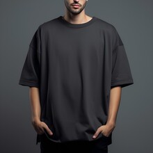 Man In Blank Black Oversize T-shirt For Design Mockup, Front View