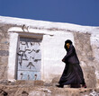 A veiled Muslim woman walks on a Sanaa street in Yemen