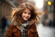 © Nerea - childhood, fashion and people concept - smiling little girl in winter jacket waving hair over city street background