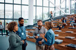 © Drazen - Multiracial group of business people communicating while attending education event at convention center.