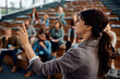 © Drazen - Businesswoman speaking to group of entrepreneurs during an education event at convention center.