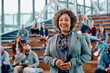 © Drazen - Happy female presenter business education event in conference hall and looking at camera.