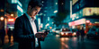© Enrique - a business asianman looking at his phone in the middle of the city, at night. space for text
