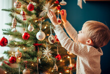 Little Boy Decorating Christmas Tree 