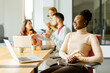 © BGStock72 - Cute Africam American woman with her young multiethnic startup team working in the modern office