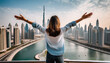 from behind you can see the traveler girl arms spread wide as she take in the incredible view of the and the dubai skyline