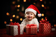 © Valeriia - Celebrating New Year Eve December holiday Christmas happy Xmas concept. Portrait of happy little toddler baby in Christmas Santa hat holding present box looking at camera on fur tree background