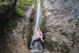 Athletic girl traveler at the Siklawica waterfall in Zakopane Poland.