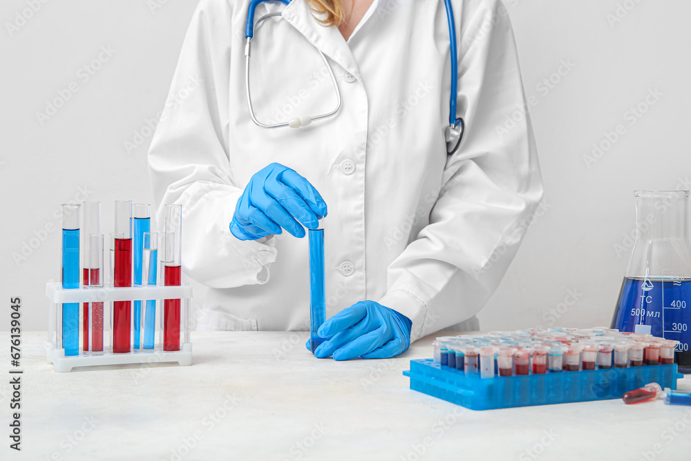 Female scientist working with colorful samples in laboratory
