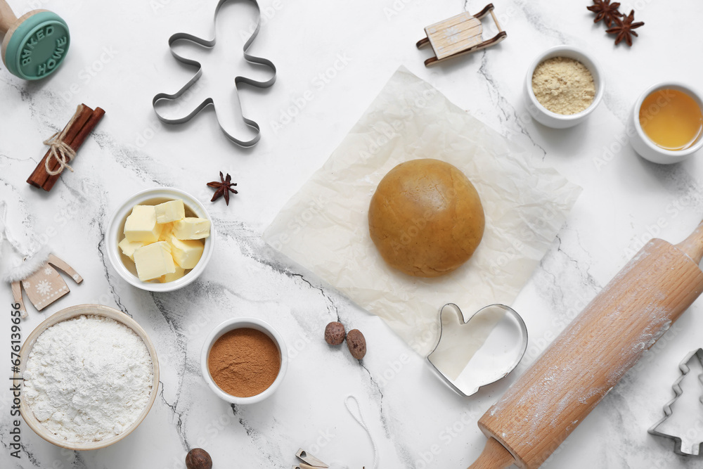 Composition with ingredients and utensils for preparing Christmas cookies on light background