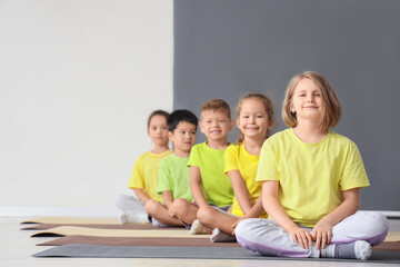 Poster - Group of little children going to practice yoga in gym