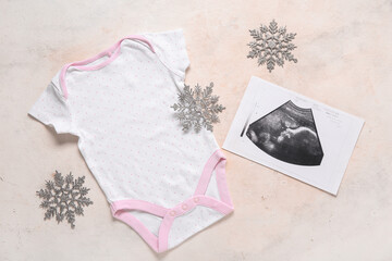 Sticker - Composition with stylish baby clothes, sonogram image and Christmas decorations on light background