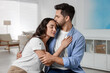 © New Africa - Cute couple. Man kissing his girlfriend at home