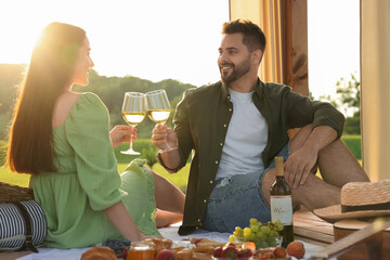 Wall Mural - Romantic date. Beautiful couple having picnic outdoors on sunny day