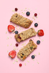 Wall Mural - Tasty granola bars and ingredients on pink background, flat lay