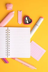 Poster - Flat lay composition with open notebook and different school stationery on yellow background, space for text. Back to school