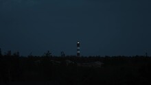 Darkness Descended, In Distance Lighthouse Sends It’s Signal Out To Sea