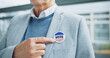 Man, hand and election vote sticker for president party cast, poll station choice or government selection. Male person, finger point at badge for politics decision support, process or usa opinion