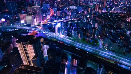 Wall Mural - A night timelapse of panoramic cityscape in Osaka high angle wide shot panning