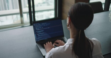 Back rear view of young woman, freelancer data scientist work remotely at office. Female data scientist coding programming on big data mining, IT technician works on artificial intelligent project