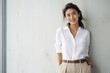 © PRASANNAPIX - Young japanese woman in white shirt and pant.