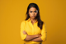 woman angry face with arm cross on yellow background
