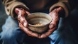 The poor old man's hands hold an empty bowl of beg you for help. The concept of hunger or poverty. Selective focus. Poverty in retirement.
