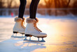 Figure skating Ice skates, standing on the ice of an open ice rink or arena. Concept of winter activities and ice-skating. Shallow field of view with copy space.