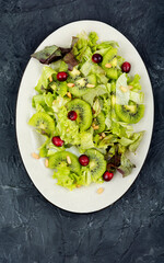 Wall Mural - Green salad of kiwi and lettuce.