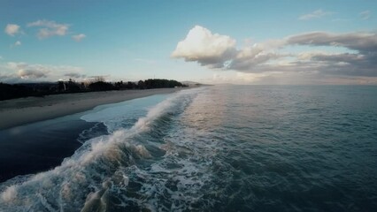 Wall Mural - Ocean water with winter clouds in evening sky aerial 