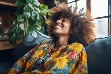 Happy afro american woman relaxing on the sofa at home - Smiling girl enjoying day off lying on the couch - Healthy life style, good vibes people and new home concept