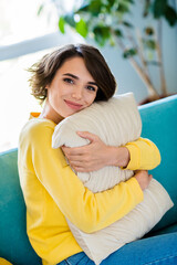 Wall Mural - Photo of gorgeous stunning girlish woman wear yellow jumper sitting sofa hug soft pillow indoors room