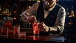 Mixologist preparing a red cocktail
