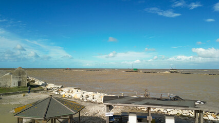 Wall Mural - Dangerous Storm. Fury of the waves on the coast, aerial view on a sunny morning