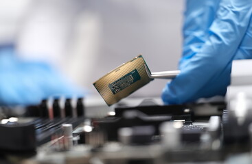 Poster - Engineer is holding microprocessor tweezers from motherboard. Microchip testing concept