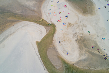  zenithal drone aerial view of a beach with people in summertime